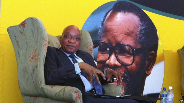 South African president Jacob Zuma, in front of a portrait of former African National Congress president Oliver Tambo, addresses foreign correspondents at a breakfast in Johannesburg, Oct. 29, 2012