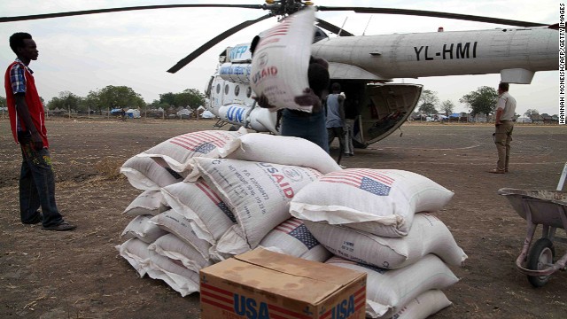 People in Jonglei state, South Sudan, unload aid from the U.N. World Food Program in January 2012