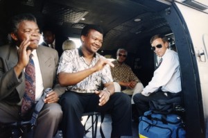Bantu Holomisa (2nd left) waves to crowds from a helicopter while Nelson Mandela looks on, (seated back right) Bantubonke Harrington Holomisa (25 July 1955) is a South African Member of Parliament and President of the United Democratic Movement (UDM). Previously a member of the ANC, he was explelled from the party after, among other things, testifying before the Truth and Reconciliation Committee in 1996.Source ANC Archives