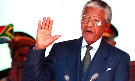 Nelson Mandela takes the oath during his inauguration as South African president in Pretoria on 10 May 1994. Photograph: Walter Dhladhla/AFP/Getty Images