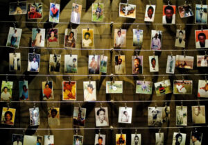 Pictures of killed people donated by survivors are installed on a wall inside the Gisozi memorial in Kigali April 5, 2004 which depicts the country's 1994 genocide in which 800,000 Tutsi and politically moderate Hutus died. Rwandans hungry for justice demanded tougher efforts to track down and punish killers who carried out the 1994 genocide, saying there could be no reconciliation while suspects were still at large.     REUTERS/Rad