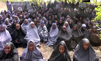 A screengrab taken on May 12, 2014, from a video of Nigerian Islamist extremist group Boko Haram obtained by AFP shows girls, wearing the full-length hijab and praying in an undisclosed rural location. -