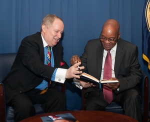National Press Club President Myron Belkind hands a pen to South African President Jacob Zuma as Zuma prepares to sign the speaker's guest book. Photo/Image: Al Teich