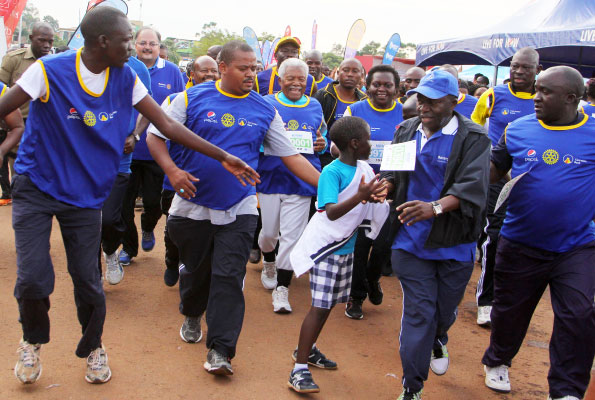 Former Tanzania president Ali Hassan Mwinyi (grey-haired) and other participants finish their race during the Cancer Run at Kololo Ceremonial grounds yesterday. More than Shs300 million was collected from the run to help complete the cancer ward at Nsambya hospital. Photo by Ismail Kezaala.