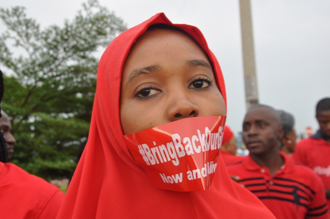 A woman attends a demonstration in Abuja, Nigeria, Thursday Sept. 11, 2014, calling on the government to rescue the kidnapped girls of the government secondary school in Chibok. (AP PHOTO/OLAMIKAN GBEMIGA)
