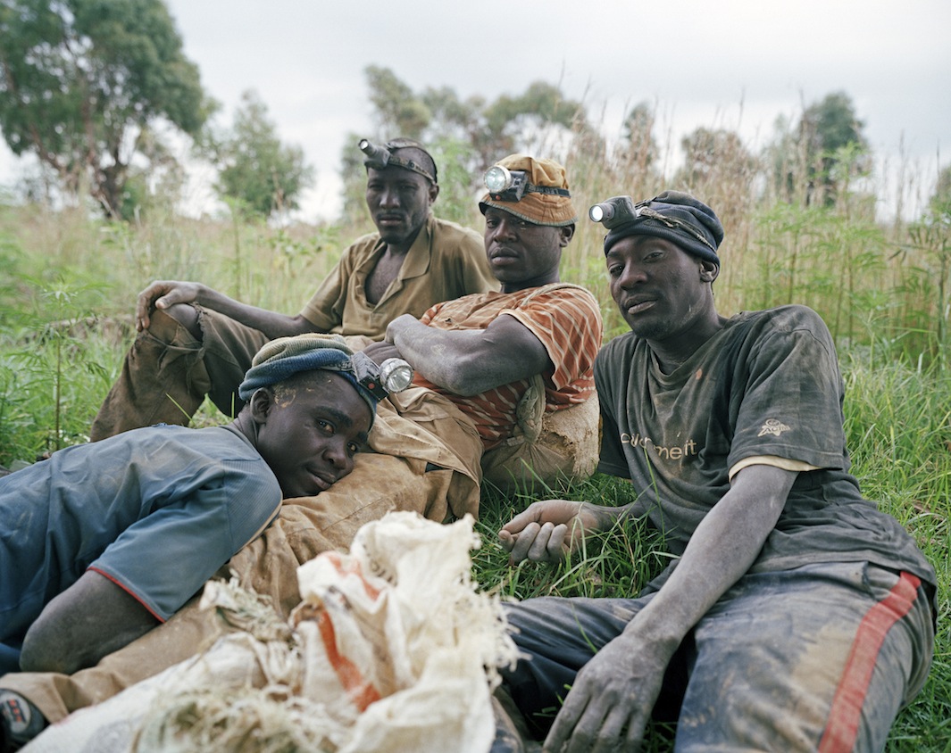 Linda Ndlovu, Daniel Mandlo, Dumisani Mahlangu, and Calvin Sibanda rest after a full night of work in a disused underground gold mine shaft. The men are highly skilled informal diggers with many years of experience. They are commonly confronted by criminals, who beat them and rob them of clothes, mining equipment, and money.