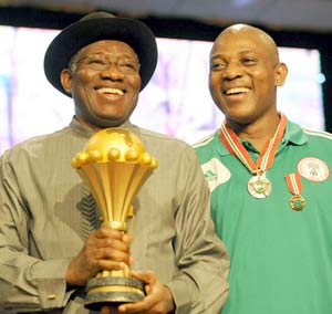 President Jonathan with the Afcon trophy pose with Super Eagles coach, Stephen Keshi at the reception
