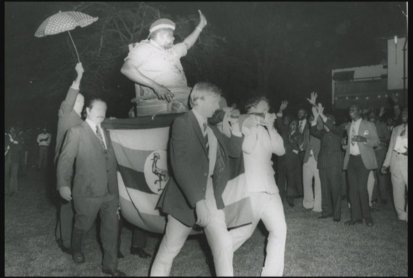 White diplomats carry Ugandan president Idi Amin in Kampala in the 1970s. Ambassador Robert V. Keeley says he became the courier of the several telegrams by Amin to US president Nixon. Right is former president Milton Obote. FILE PHOTO