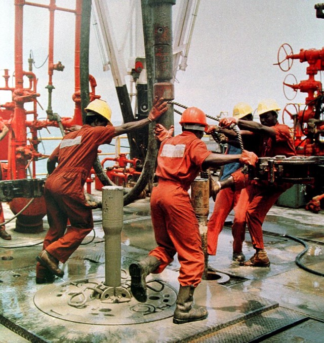 Men work on an oil rig in Nigeria. Photographer: Stringer/AFP via Getty Images