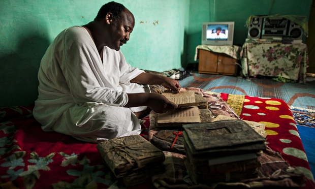 Librarian Abdel Haidara in his home in Timbuktu in 2009 with some of the manuscripts before they were taken to safety. Photograph: Brent Stirton/Getty Images