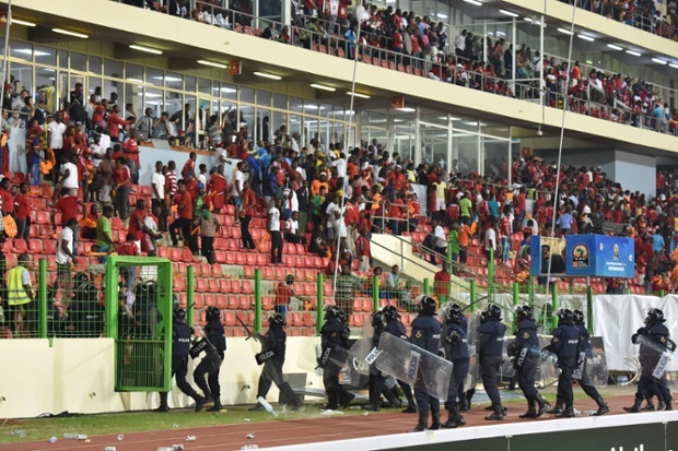 Police evacuate a tribune as the match is halted eight minutes from time.