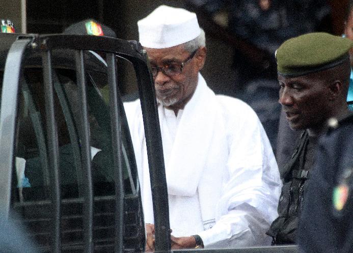 Former Chadian dictator Hissene Habre is escorted by military officers after being heard by judge on July 2, 2013 in Dakar, Senegal (AFP Photo/)