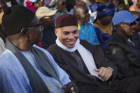Karim Wade (C), son of Senegal's former president Abdoulaye Wade, attends a rally by his father's political party Parti Democratique Senegalais (PDS) in Dakar December 6, 2012. REUTERS/Joe Penney