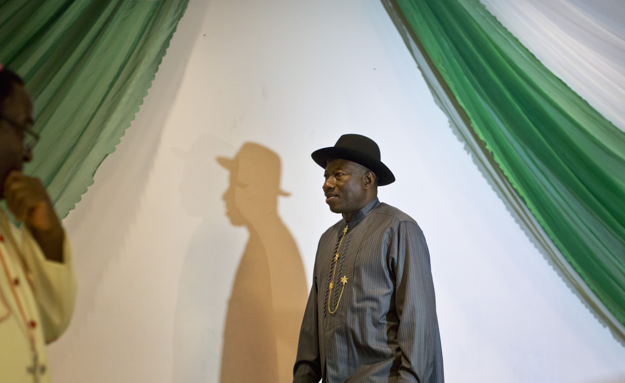 Nigerian President Goodluck Jonathan, center, arrives on stage to sign a joint renewal with opposition candidate Gen. Muhammadu Buhari of their pledge to hold peaceful "free, fair, and credible" elections, at a hotel in the capital Abuja, Nigeria Thursday, March 26, 2015. Nigerians are due to go to the polls to vote in presidential elections on Saturday. (AP Photo/Ben Curtis)