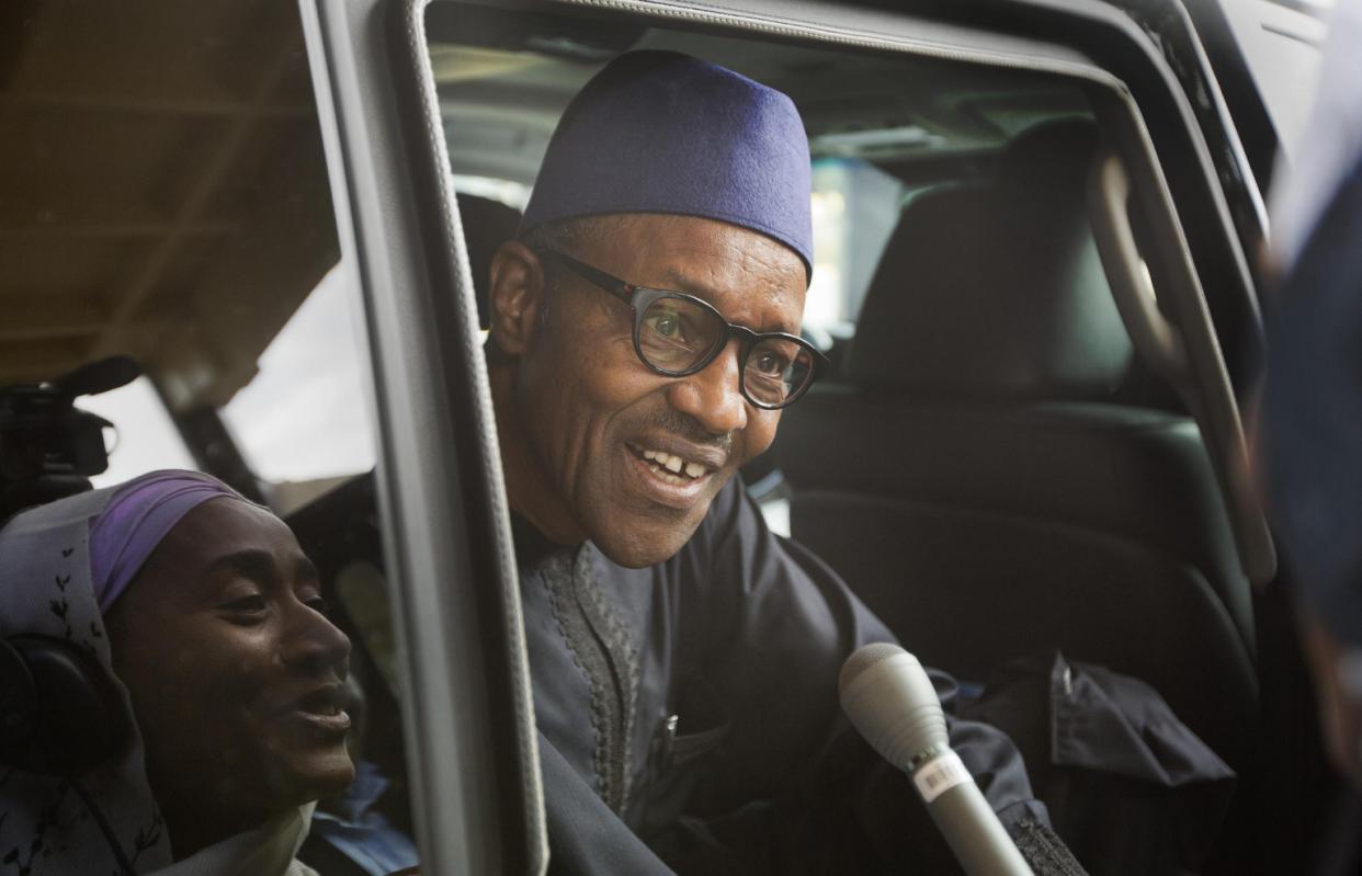 Nigerian opposition candidate Gen. Muhammadu Buhari speaks to reporters as he gets into his vehicle after signing a joint renewal with President Goodluck Jonathan of their pledge to hold peaceful "free, fair, and credible" elections, at a hotel in the capital Abuja, Nigeria Thursday, March 26, 2015. Nigerians are due to go to the polls to vote in presidential elections on Saturday. (AP Photo/Ben Curtis)