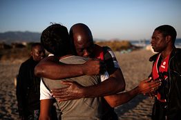 A migrant from Gambia embraces a friend in Kos, Greece, after arriving in a small boat from Turkey. Agence France-Presse/Getty Images