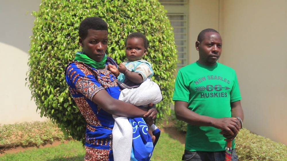 Muhawenimana (right) with his wife Dusabimana and the baby who was born in prison