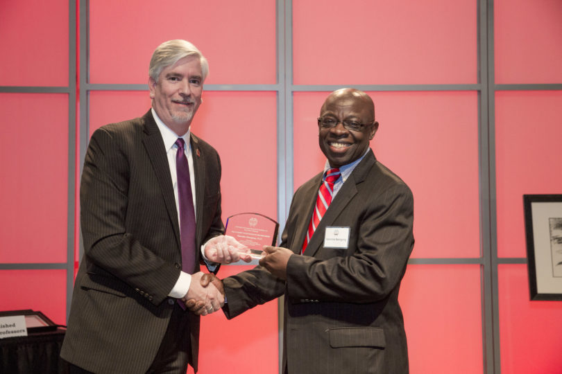 Valentine Nzengung, right, receives the Academic Entrepreneur of the Year Award in 2016 from Derek Eberhart, associate vice president for research. (UGA file photo)