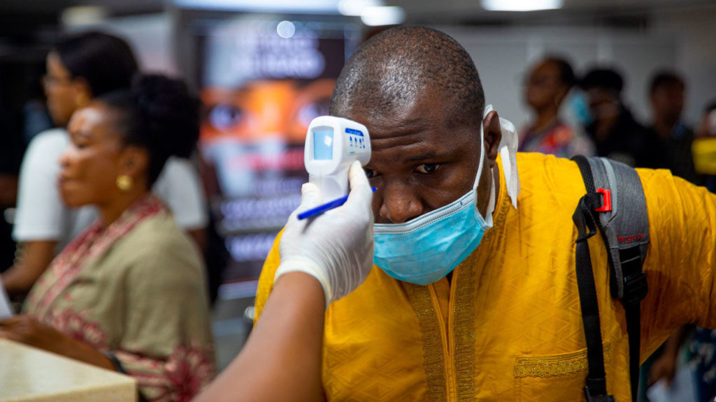 A passenger's body temperature is being tested at the gate of entry upon arrival at the Murtala International Airport in Lagos, on March 2, 2020. - Nigeria is monitoring 58 people who had contact with an Italian man infected with the new coronavirus, the health minister said Monday, as officials scrambled to stop the disease spreading. Africa's most populous country on Friday confirmed the first case of the virus in sub-Saharan Africa after the patient was diagnosed in the economic hub Lagos. (Photo by BENSON IBEABUCHI / AFP) (Photo by BENSON IBEABUCHI/AFP via Getty Images)