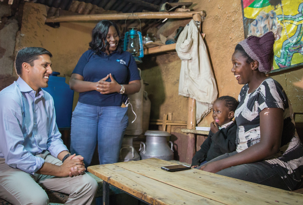 Dr. Rajiv J. Shah meets with a mother and her daughter to talk about The Rockefeller Foundation’s work to bring electricity and lighting to the Kibera area in Kenya. | Photograph by Chad Holder