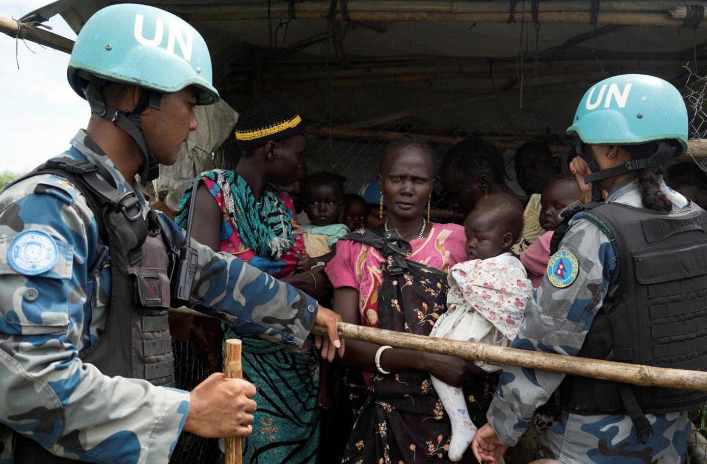 UN. peacekeepers engage with South Sudanese women and children before emergency supplies are distributed at a protection of civilians site in Juba .Photo credit Adriane Ohanesian/Reuters