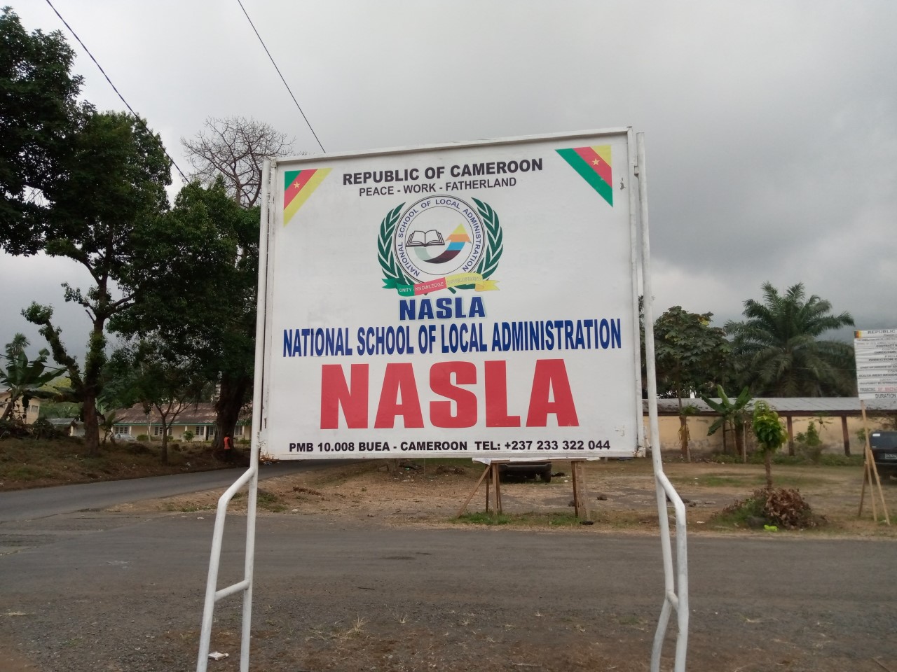 A sign post indicating the campus of the National School of Local Administration, NASLA in Buea