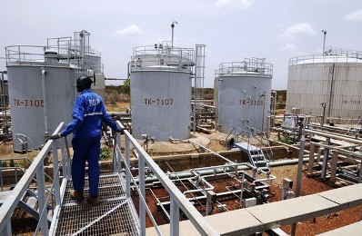 A-worker-walks-at-the-power-plant-of-an-oil-processing-facility-at-an-oilfield-in-Unity-State