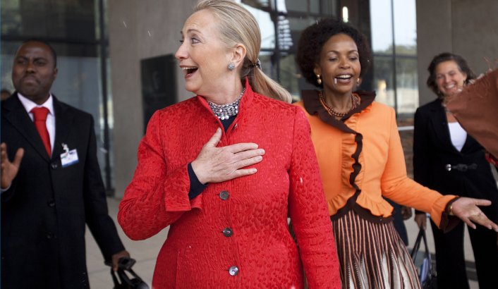 U.S. Secretary of State Hillary Clinton (2nd L) and South Africa's Foreign Minister Maite Nkoana-Mashabane (2nd R) react to a rare snow flurry as they leave business meetings in Pretoria August 7, 2012. REUTERS/Jacquelyn Martin