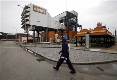 A man walks in front of a plant of Ivory Coast power company Ciprel in Abidjan in this June 12, 2012 file photo. REUTERS/Thierry Gouegnon/Files