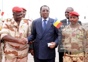 Chad's President Idriss Deby Itno (C) shakes hands with general of the Chadian contingent in Mali Oumar Bikimo (L) and second-in-command major and his son Mahamat Idriss Deby Itno (R) during a welcome ceremony, on May 13, 2013, in N'Djamena. Some 700 Chadian soldiers returned home to a heroes' welcome after a bloody campaign fighting Islamic insurgents in northern Mali. AFP PHOTO / STR (Photo credit should read STR/AFP/Getty Images)