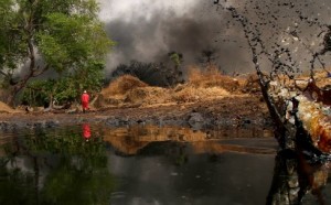 A man walks away as crude oil spills from a pipeline in Dadabili, Niger state, April 2, 2011. (Afolabi Sotunde / Courtesy Reuters)