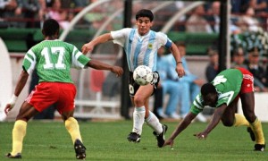 Argentina's Diego Maradona juggles with the ball as he runs past Cameroon's Benjamin Massing. Photograph: Daniel Garcia/AFP/Getty Images