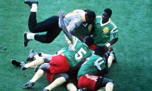 Cameroon players pile on top of each other as they celebrate the only goal. Photograph: Bob Thomas/Bob Thomas/Getty Images