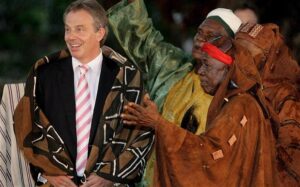 Tony Blair (L) wears a ceremonial robe after being made an Honorary Paramount Chief of Mahera Village on 30 May 2007 near Freetown, Sierra Leone. His charity has been given £3m for aid work in Africa by the US Government. Photo: EPA