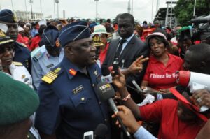 Gbenga Olamikan/AP - Air Chief Marshal Alex Badeh, the government’s chief of defense staff, center, speaks during a demonstration Monday calling on the government to rescue the kidnapped girls.