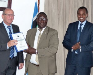 Michel Fest, the director of Gauff Ingenieure consultants (L), Uganda’s Permanent Secretary in the Ministry of Works and Transport Okello Bwangamoi (C) and Guy Kalisa, the director-general of Rwanda Transport Development Agency, after signing the contract in Kampala yesterday. Gashegu Muramira.