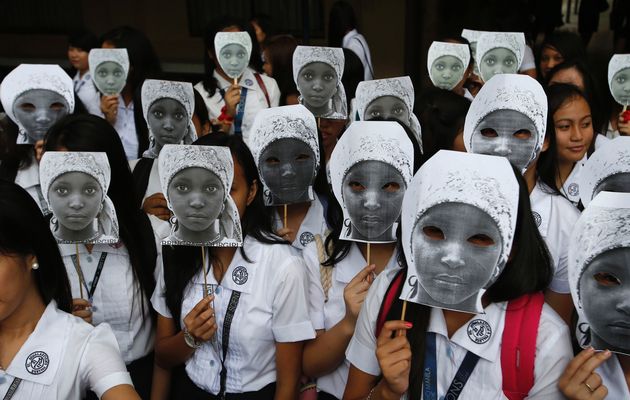 Students from an all-girls Catholic school, St Scholastica's College, wear masks depicting kidnapped African school girls in Manila, June 27, 2014. More than 1,000 girls took part in the protest outside their campus aimed at voicing outrage over the kidnapping of more than 200 girls from a school in northeast Nigeria in April by Boko Haram militants, a school official said. Image by: ERIK DE CASTRO / REUTERS