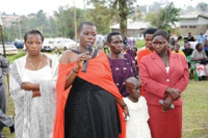 Gloria Tumwijuke (with microphone), Alice Ngonzi Isoke (folding hands in red dress), Diana Alinaitwe (behind Alice), Mrs Isoke (Alice’s mother), an unidentified health worker(on Gloria’s right) and a granddaughter to Mrs Isoke – all Ebola survivors narrating their ordeal at Kagaadi Hospital during the function to officially declare Uganda Ebola free. Photo courtesy WHO -