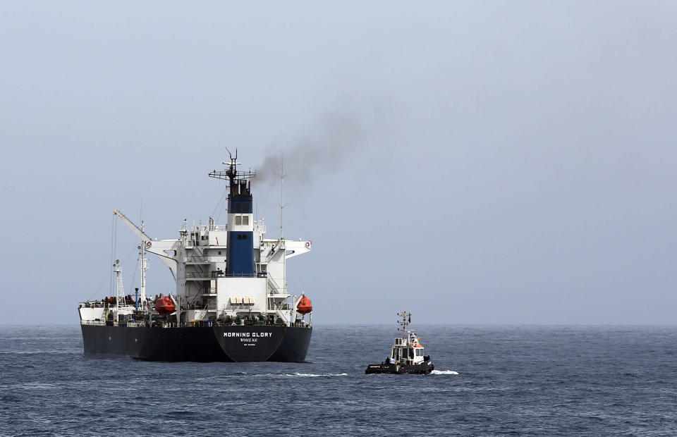 An oil tanker during the unloading of oil in the Libyan sea port of Zawiya on April 4, 2014 (AFP Photo/Mahmud Turkia)