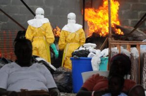 Health care workers wearing full body suits burn infected items at the Elwa hospital run by Medecins Sans Frontieres in Monrovia on August 30, 2014 (AFP Photo/Dominique Faget)