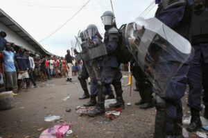 Riot police hold people back at the West Point slum in Monrovia, Liberia. The slum was quarantined following the Ebola outbreak, leading to protests from residents. Photo: John Moore/Getty Images