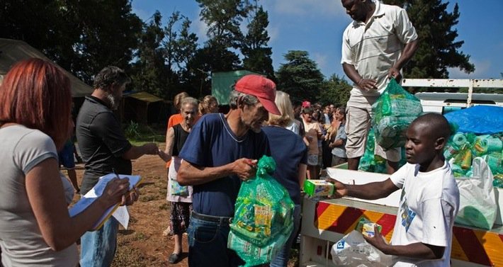 A man receives a monthly supply of food aid donated to residents of a squatter camp for poor white South Africans, at Coronation Park, in Krugersdorp, on March 6 2010. Photo©Finbarr O'Reilly/Reuters