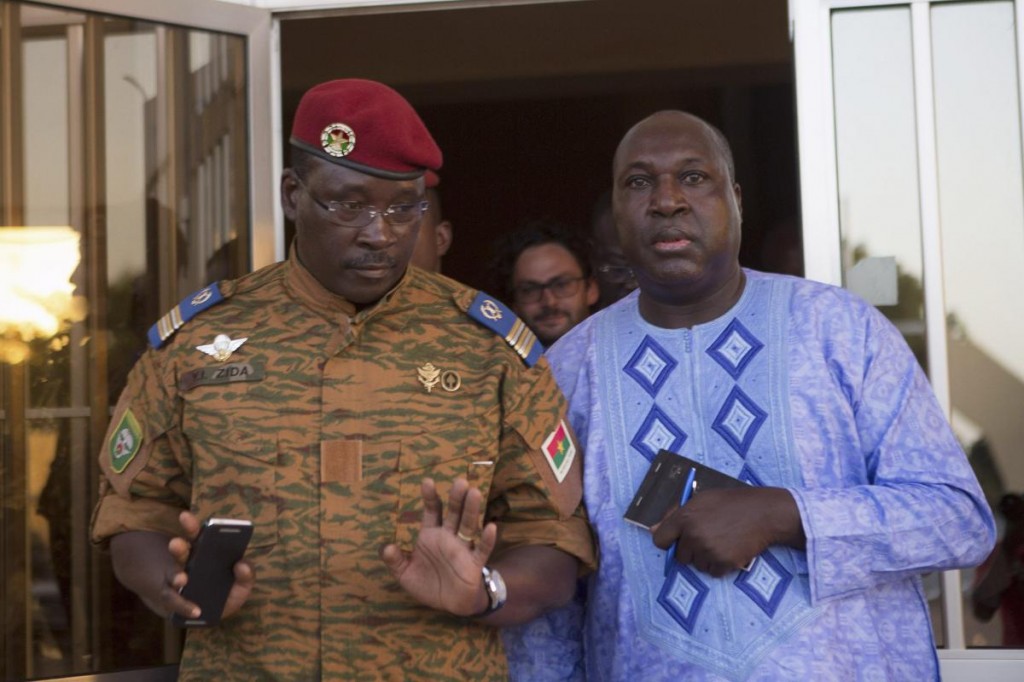 Lieutenant Colonel Yacouba Isaac Zida (L) meets with opposition leader Zephirin Diabre in Ouagadougou, capital of Burkina Faso, November 2, 2014. Burkina Faso's army cleared thousands of protesters from the capital and fired warning shots at state TV headquarters on Sunday as it sought to tighten its grip on power following the resignation of President Blaise Compaore two days ago. REUTERS/Joe Penney (BURKINA FASO - Tags: POLITICS CIVIL UNREST MILITARY)