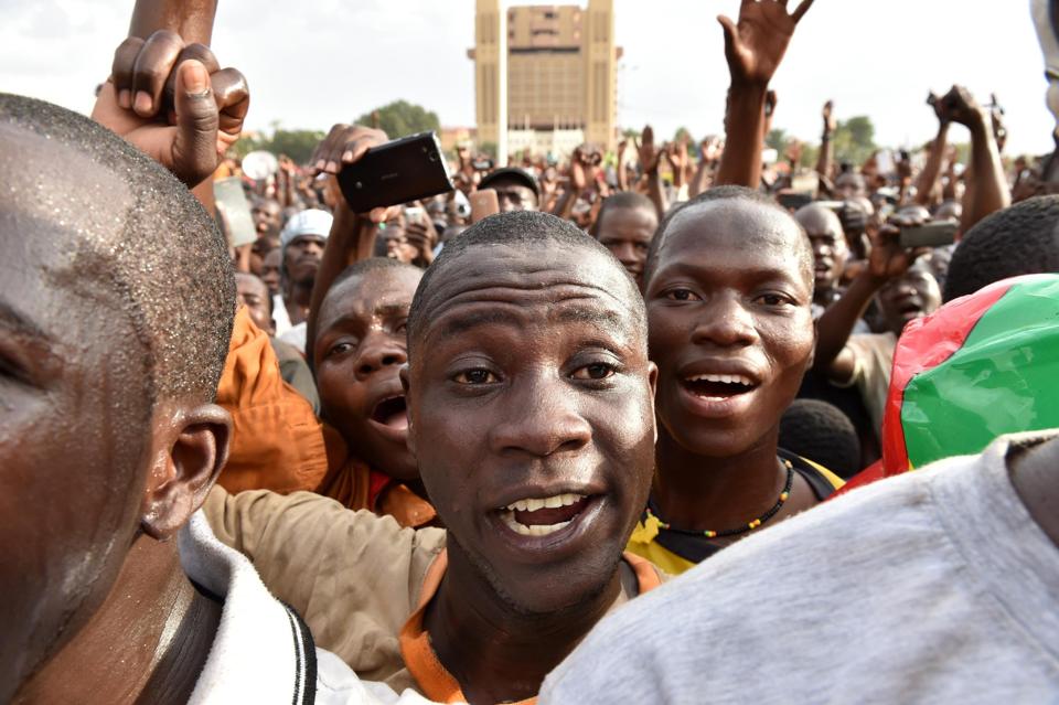 Burkinabe react as they listen to a lieutenant-colonel reading a press release by the army chief after the resignation of Burkina Faso's president in Ouagadougou on October 31, 2014 (AFP Photo/Issouf Sanogo)