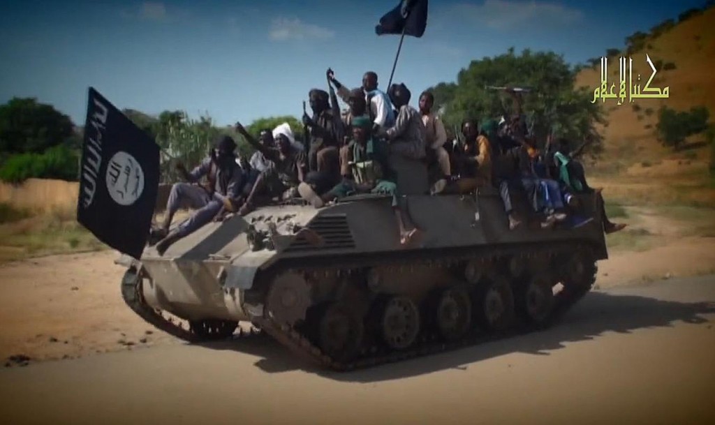 A screengrab taken on November 9, 2014 from a video released by Nigerian Islamist extremist group Boko Haram fighters parading on a tank in an unidentified town (AFP Photo/)