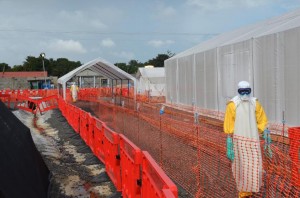 Health workers in protective gear stand outside an Ebola treatment centre in Monrovia (AFP Photo/Zoom Dosso)