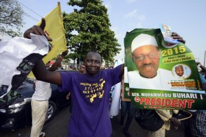 A party supporter holds a poster of the opposition All Progressives Congress presidential aspirant Mohammadu Buhari, at the party's presidential primary in Lagos on December 11, 2014 (AFP Photo/Pius Utomi Ekpei)