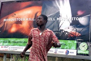 FILE- In this Friday, Sept. 12, 2003, file photo, An unidentified man runs past a billboard with the picture of a mosquito biting a human face in Lagos, Nigeria. The operation to fight Ebola in West Africa has hampered the campaigns against malaria, a preventable and treatable disease that is claiming many thousands of lives. In information released Sunday Dec. 28, 2014, Dr. Bernard Nahlen, deputy director of the U.S. President’s Malaria Initiative says they have had to stop pricking fingers to do blood tests for malaria, so statistics show a decrease in reported cases of maleria but the decrease is likely because people are too scared to go to health facilities and are not getting treated for malaria.(AP Photo/George Osodi, FILE) 