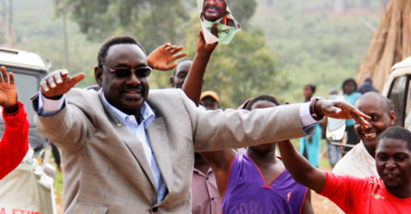 The former coordinator of Intelligence Services, Gen David Sejusa, flashes different political party signs as he greets onlookers and supporters on the Kampala Northern Bypass yesterday. PHOTOS BY ABUBAKER LUBOWA