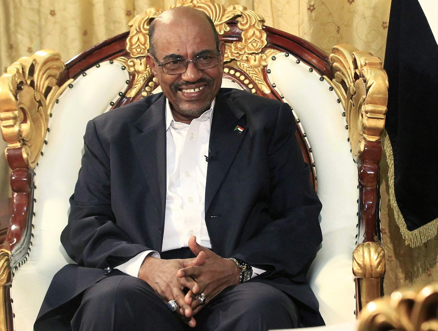 Sudan's President Omar al-Bashir smiles during an interview with the Russia Today news channel at the Presidential Palace in Khartoum, December 3, 2014. (Mohamed Nureldin Abdallah/Reuters)